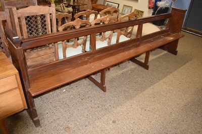 Lot 317 - A large 20th Century hardwood Church pew with...