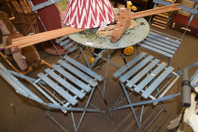 Lot 753 - A metal framed cafe table and four chairs