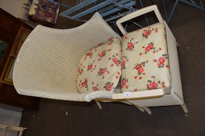 Lot 754 - A Lloyd Loom chair and accompanying stool