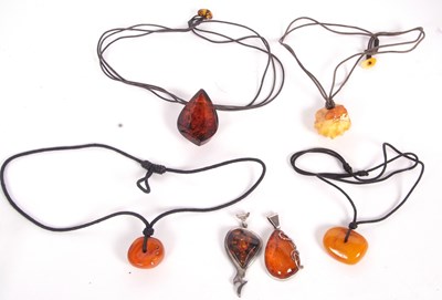 Lot 281 - Six amber pendants: to include a pear shaped...