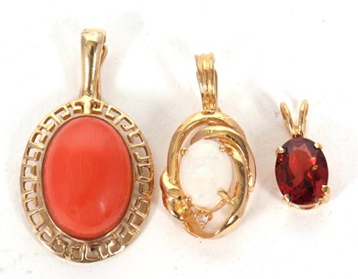 Lot 144 - Three gemset pendants: to include an oval...