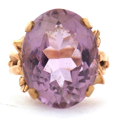 Lot 14 - An amethyst ring, the oval mixed cut amethyst...