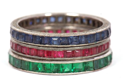 Lot 33 - Three gemset eternity rings: to include a...