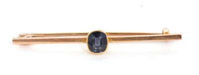 Lot 115 - A spinel bar brooch, the cushion cut dark blue...