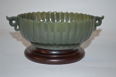 Lot 205 - A small spinach green jade bowl of fluted form...