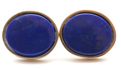 Lot 84 - A pair of lapis lazuli ear studs, the oval...