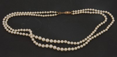 Lot 242 - A cultured pearl necklace, the two graduated...