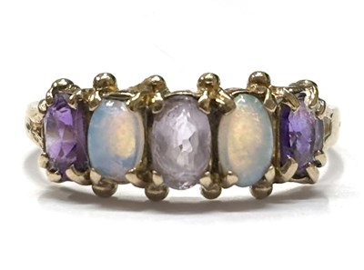 Lot 65 - A 9ct amethyst and opal ring, the alternating...