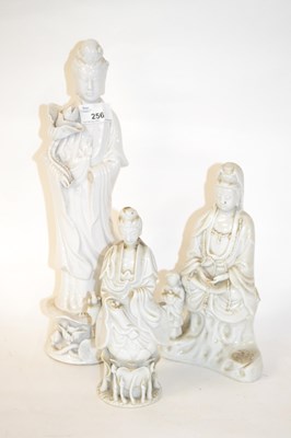 Lot 256 - Three Chinese blanc de chine models of Guanyin,...