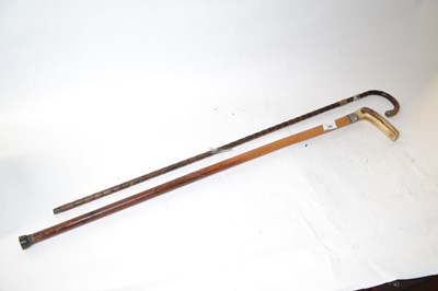 Lot 540 - A small walking cane with yellow metal banding...