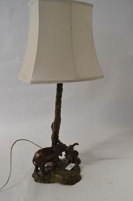 Lot 552 - A bronzed metal table lamp, the base and stem...