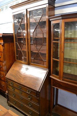 Lot 619 - A Georgian mahogany bureau bookcase with...