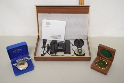 Lot 75 - A cased pair of 8 x 12 binoculars with compass...