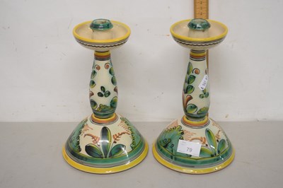 Lot 79 - A pair of Spanish pottery candlesticks