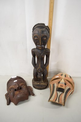 Lot 176 - An African carved softwood figure together...