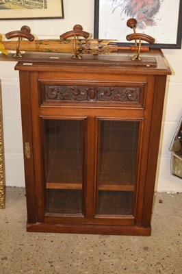 Lot 297 - A late Victorian American walnut glazed side...