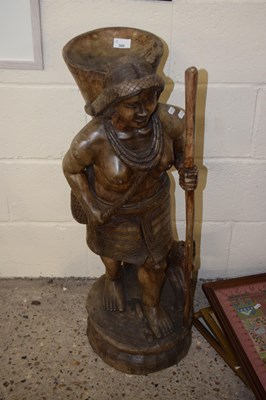 Lot 300 - A carved hardwood figure with dog