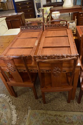 Lot 353 - A Chinese hardwood dining suite comprising...