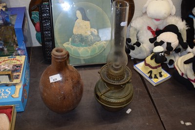 Lot 625 - A salt glazed jar together with an oil lamp