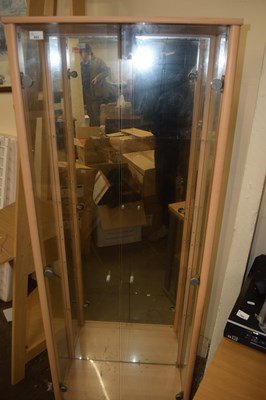 Lot 693 - A two door glazed display cabinet with lights