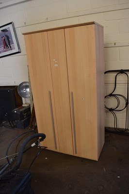 Lot 724 - A pine effect wardrobe