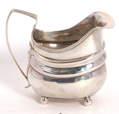 Lot 7 - A George III silver cream jug of oval form...