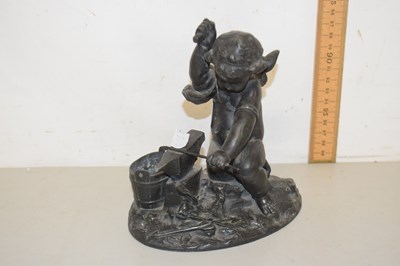 Lot 60 - A Spelter model of a cherub with an anvil