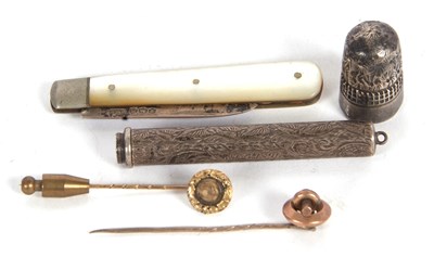 Lot 177 - A hallmarked silver thimble, a silver bladed...