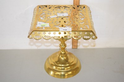 Lot 5 - A pierced brass trivet raised on knopped brass...