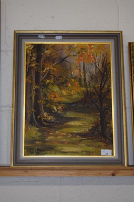 Lot 34 - A framed oil on canvas of autumnal woodland...