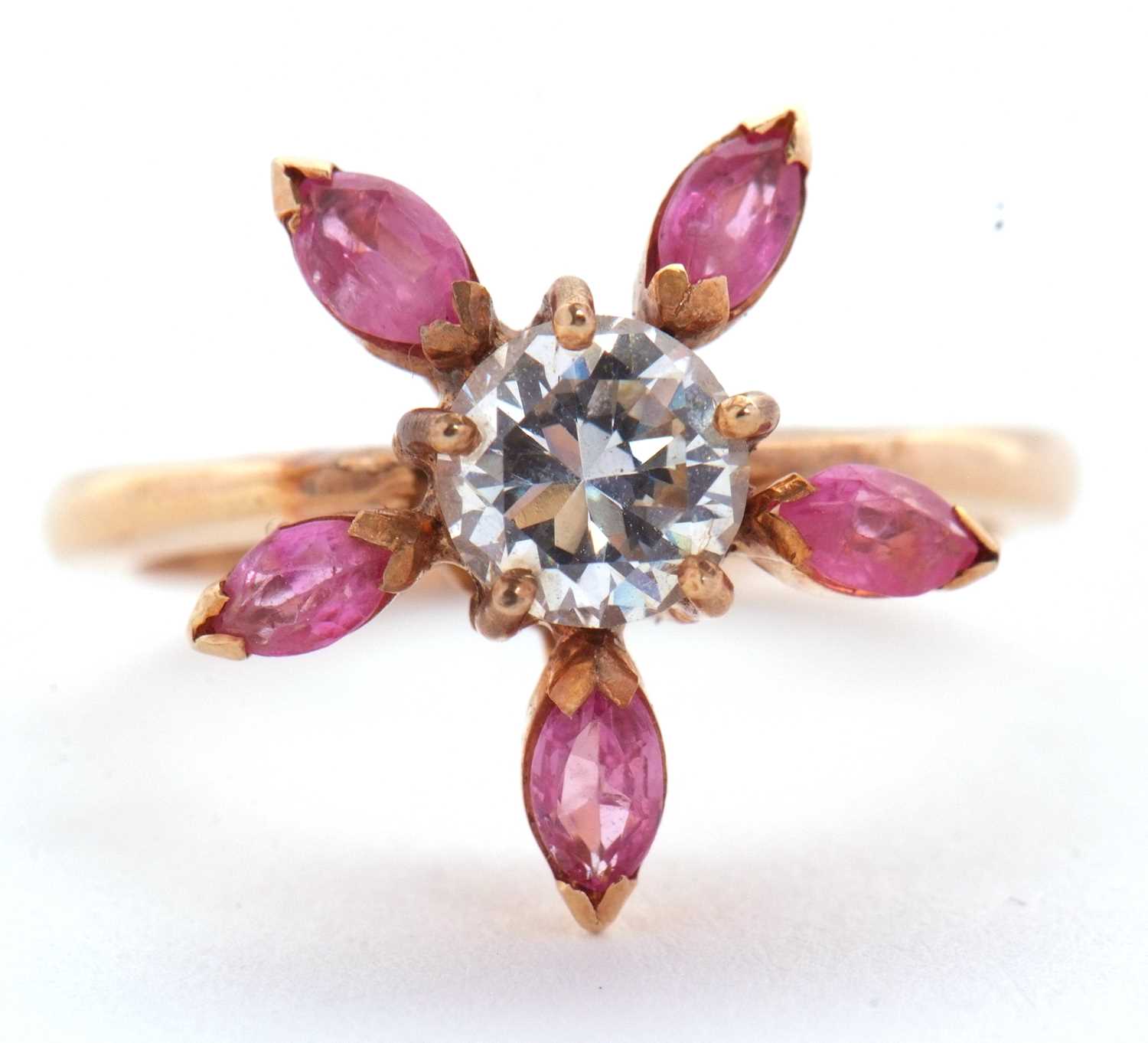 Lot 25 - A pink sapphire and CZ ring, the central round...