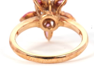 Lot 25 - A pink sapphire and CZ ring, the central round...