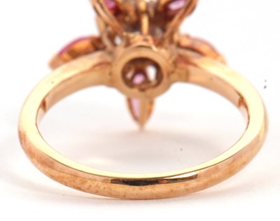 Lot 25 - A pink sapphire and CZ ring, the central round...