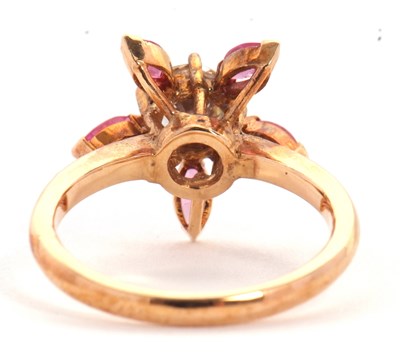 Lot 25 - A pink sapphire and CZ ring, the central round...
