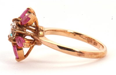 Lot 25 - A pink sapphire and CZ ring, the central round...