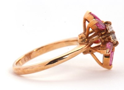 Lot 25 - A pink sapphire and CZ ring, the central round...