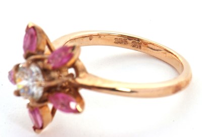 Lot 25 - A pink sapphire and CZ ring, the central round...