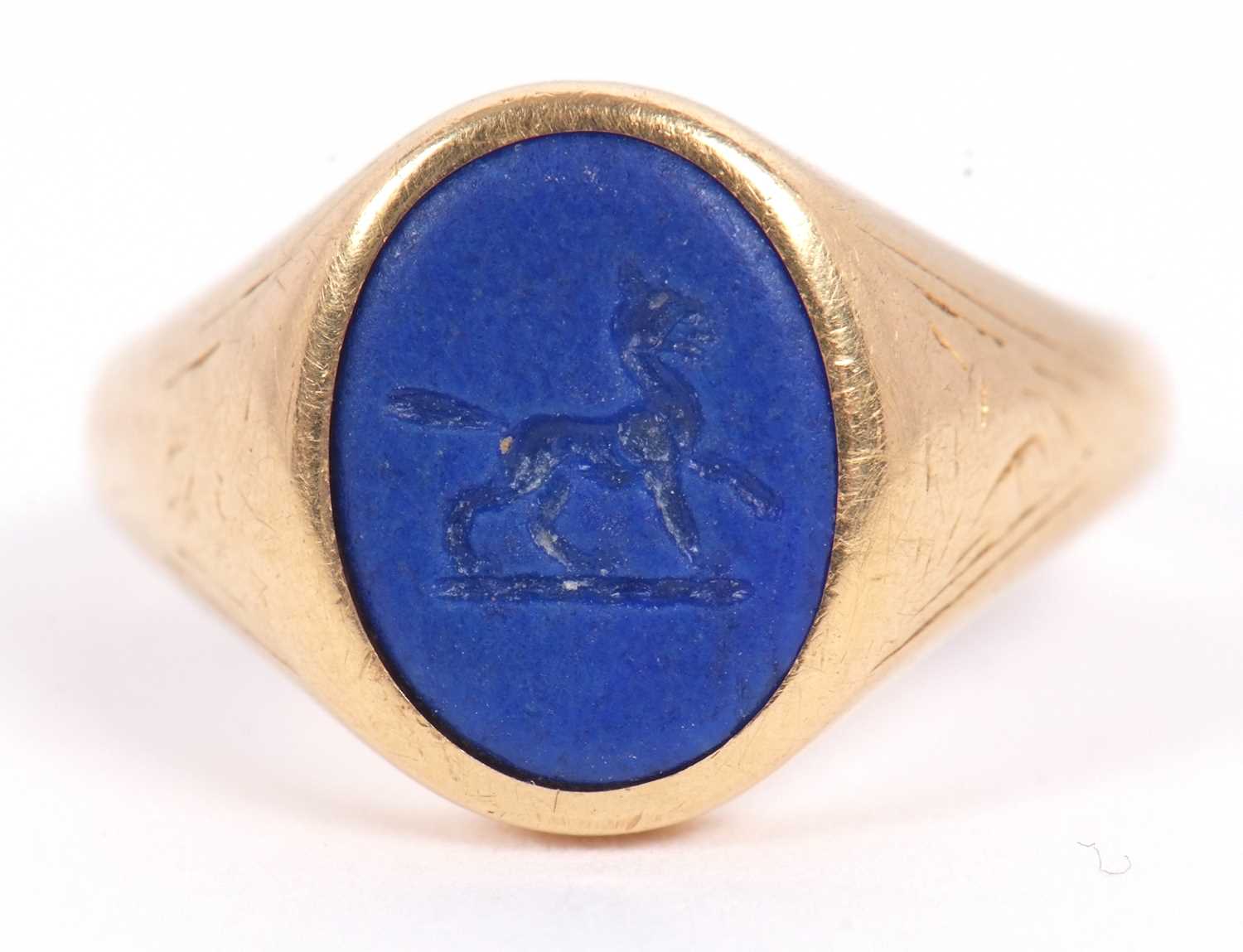 Lot 13 - An 18ct signet ring, set with an oval blue...