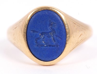 Lot 13 - An 18ct signet ring, set with an oval blue...