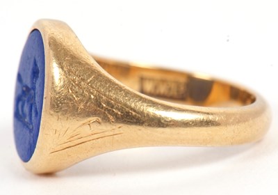 Lot 13 - An 18ct signet ring, set with an oval blue...