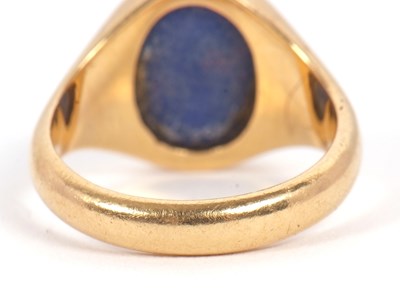 Lot 13 - An 18ct signet ring, set with an oval blue...