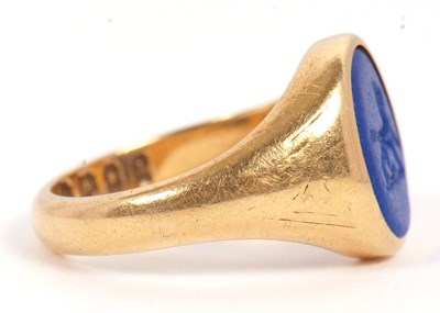 Lot 13 - An 18ct signet ring, set with an oval blue...