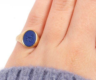 Lot 13 - An 18ct signet ring, set with an oval blue...