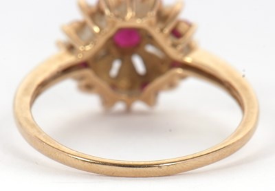 Lot 43 - A 9ct ruby and opal ring, set with a central...