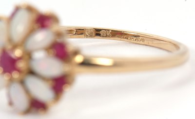 Lot 43 - A 9ct ruby and opal ring, set with a central...