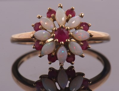 Lot 43 - A 9ct ruby and opal ring, set with a central...