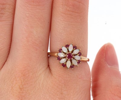 Lot 43 - A 9ct ruby and opal ring, set with a central...