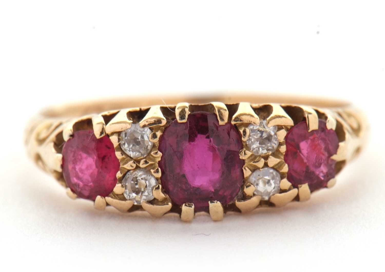 Lot 48 - An 18ct garnet and diamond ring, the three...