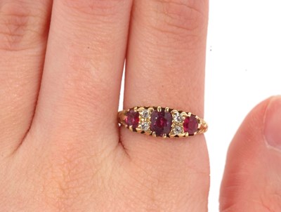 Lot 48 - An 18ct garnet and diamond ring, the three...