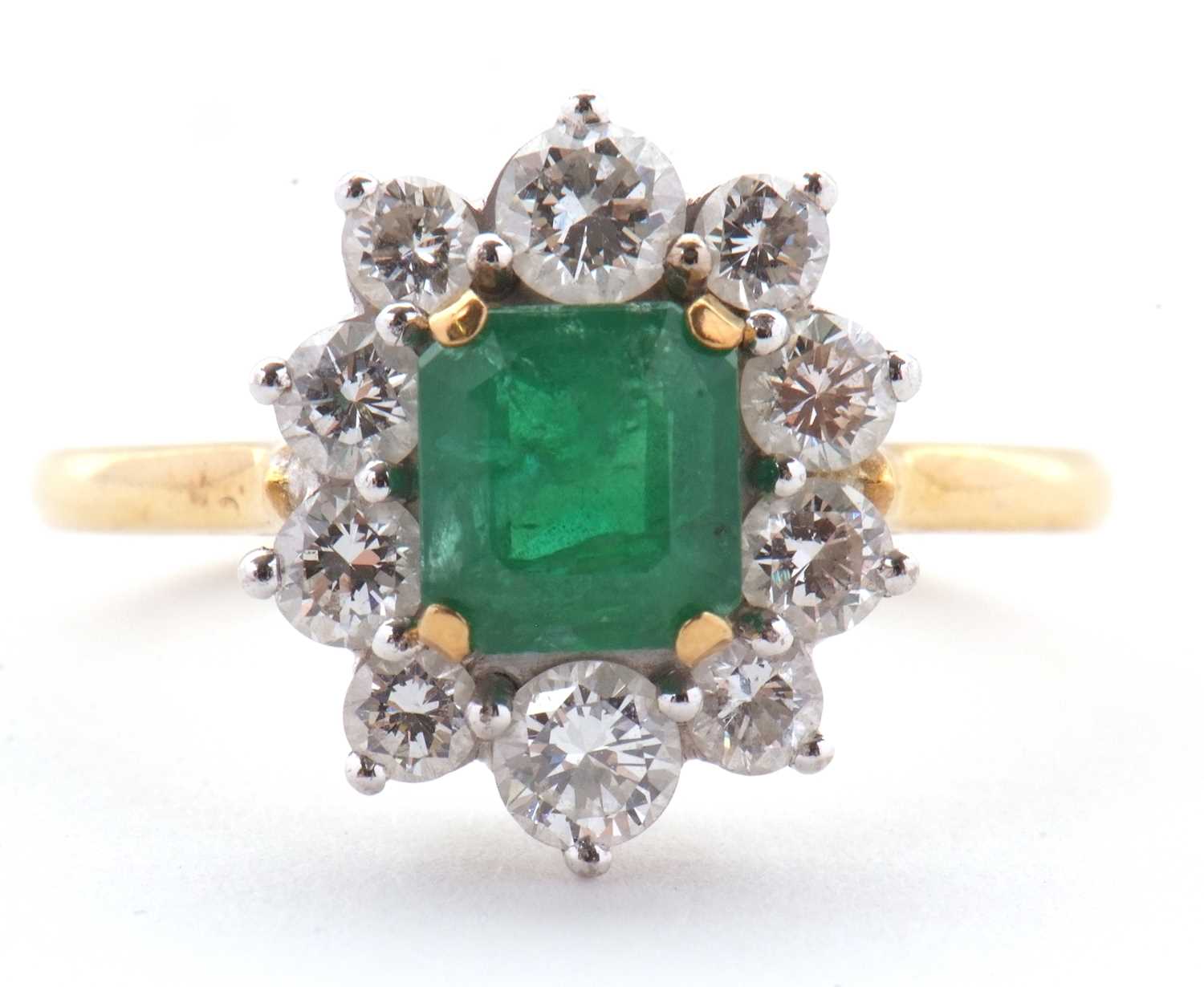 Lot 74 - An 18ct emerald and diamond ring, the central...